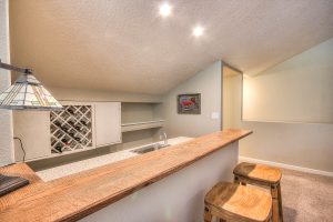 A custom designed bar with wood trim and granite countertops.