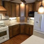 Newly remodeled custom kitchen with wooden cabinets and granite countertops