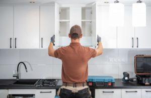 picture of remodeling specialist installing kitchen cabinets
