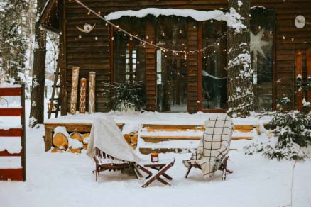 Cabin Home Exterior Yard Covered in Snow