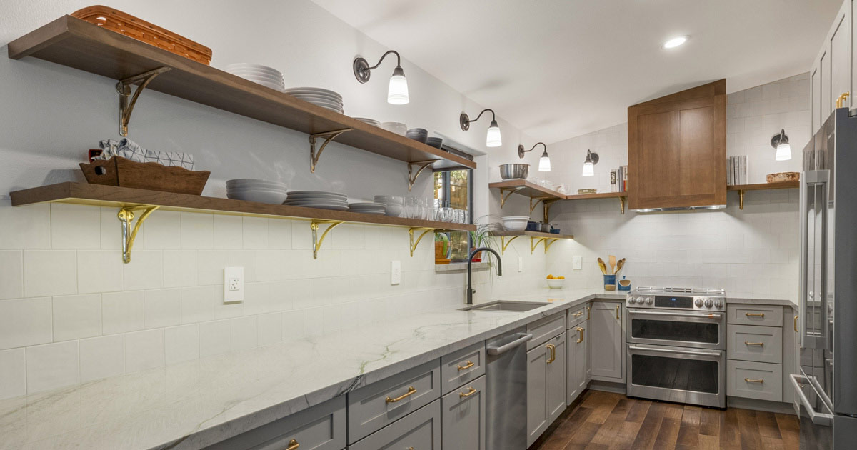 Kitchen with grey cabinets and dark wood open shelving