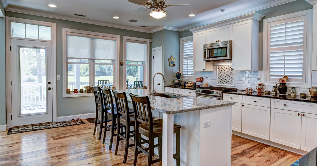 Modern kitchen with large island and different counter finishes