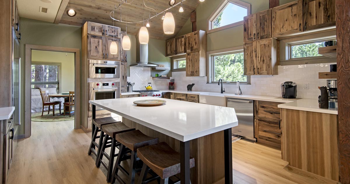 Cabin-style kitchen remodel with wood finish cabinets and large island