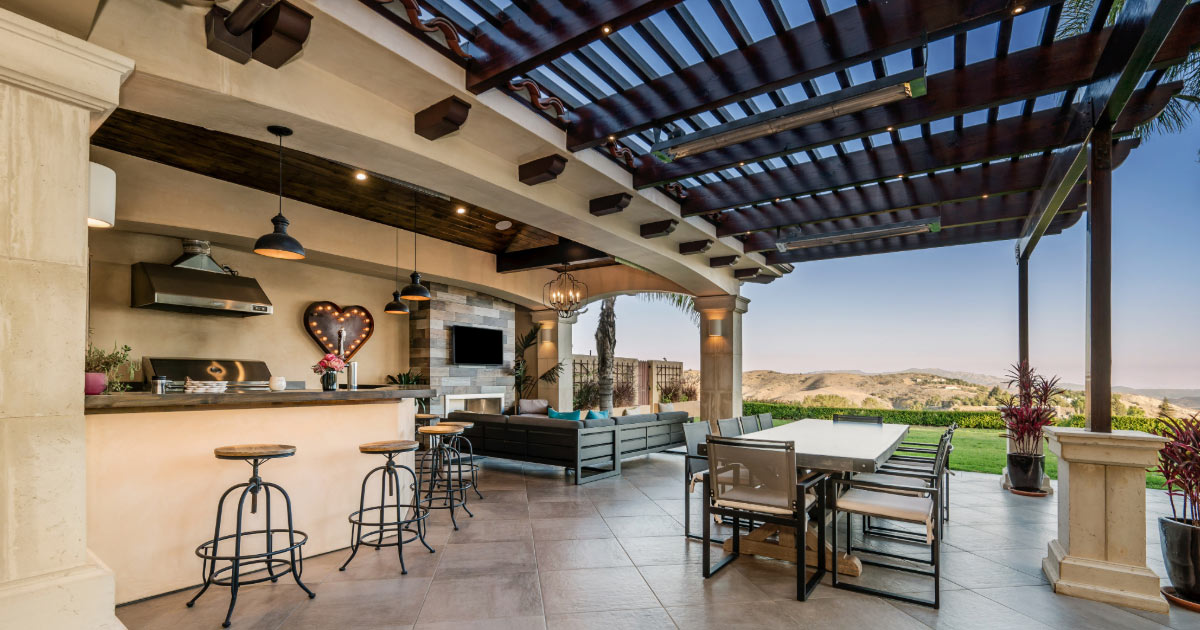 Outdoor kitchen with tile flooring, countertops, and pergola patio