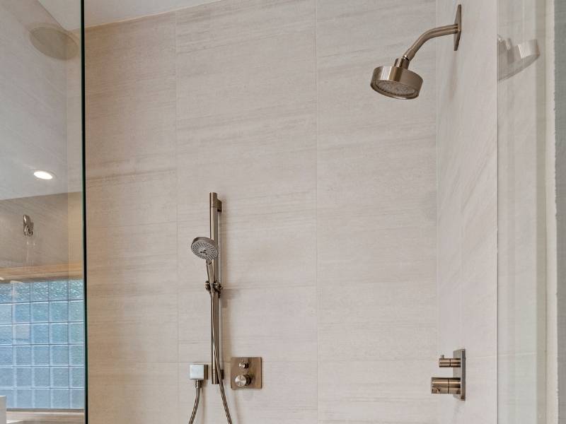 glass walk-in shower with chrome fixtures