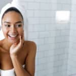 Woman wearing towels after stepping out of walk-in shower