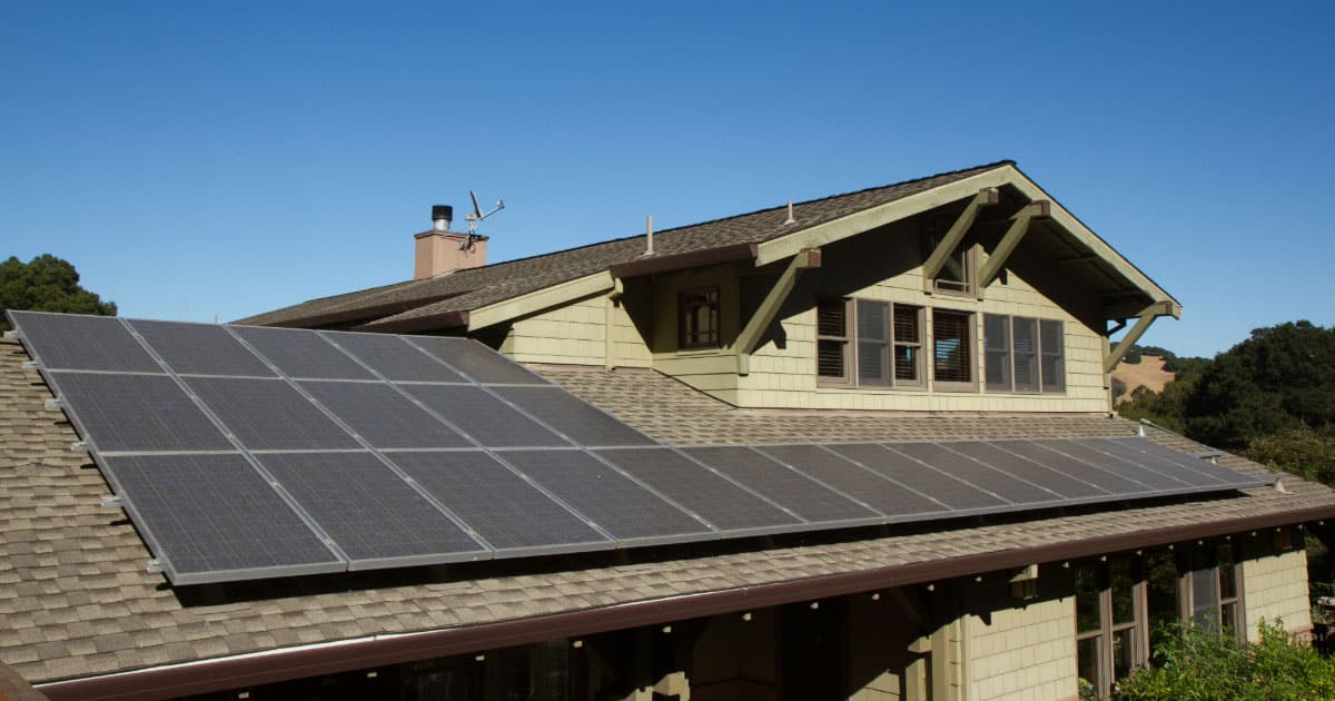 Modern sustainable home with solar panels installed on the roof
