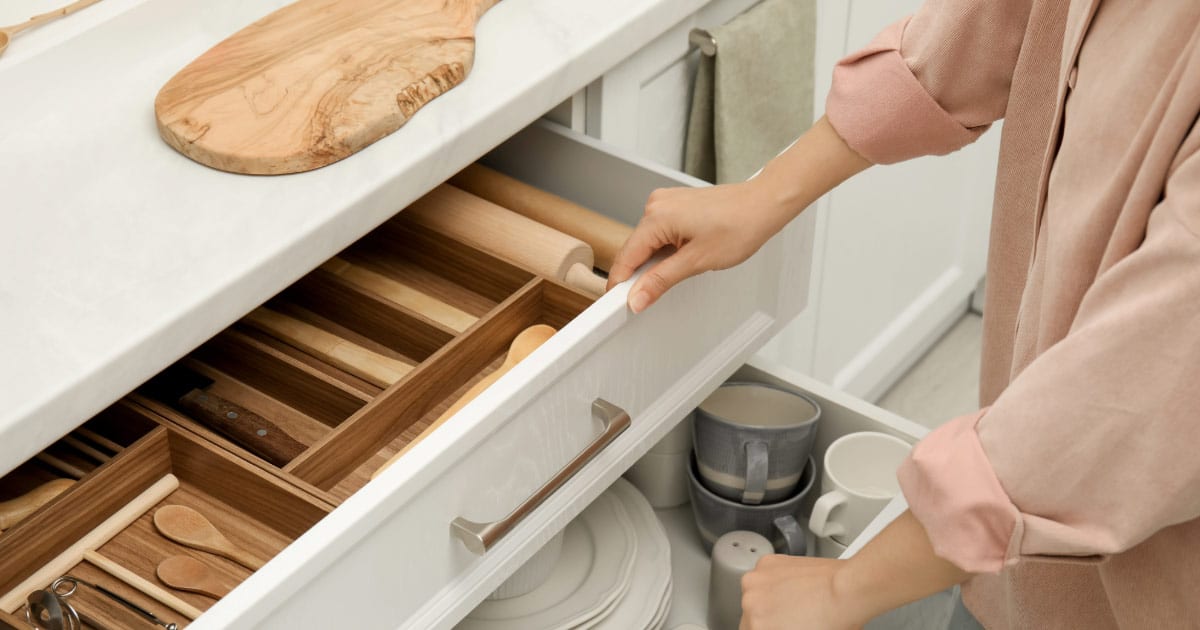 Woman showing off her new large kitchen drawers for storage