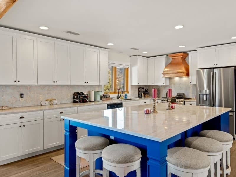kitchen remodel with white cabinets and a blue island